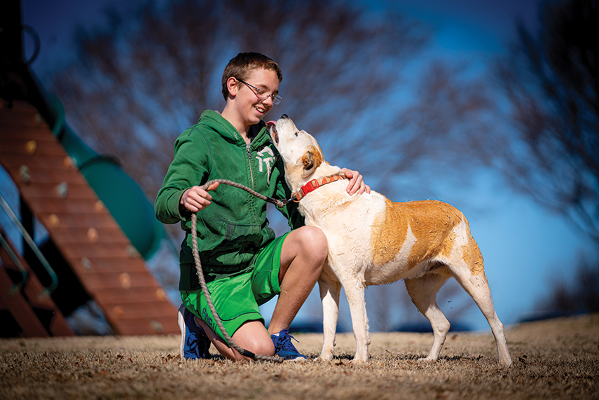 OBHC resident playing with his dog outside