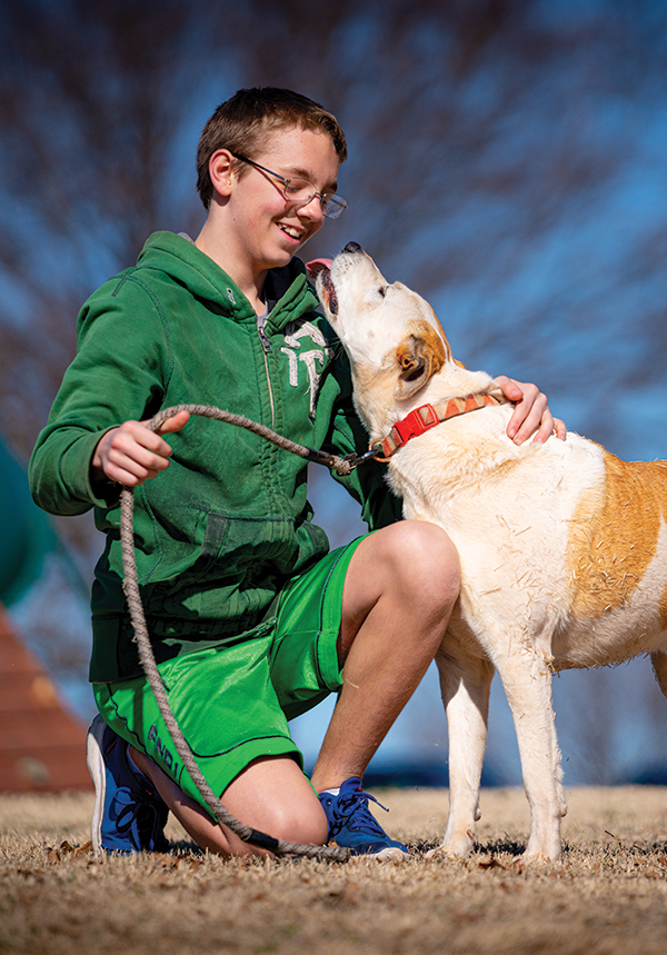 OBHC resident playing with his dog outside