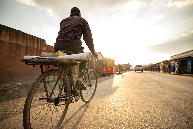 Man riding bicycle down street