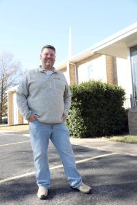 Image of Pup Rogers in front of his church