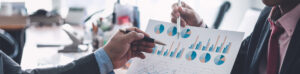 Businessmen looking at investment graphs